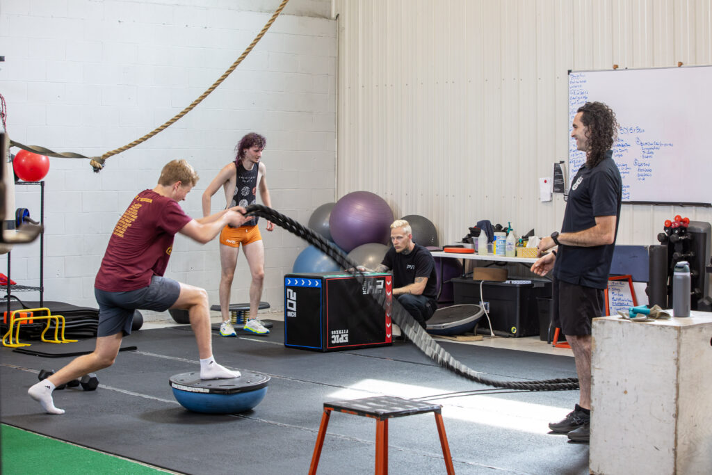 P.I.T. group training session with multiple athletes working together under coach supervision