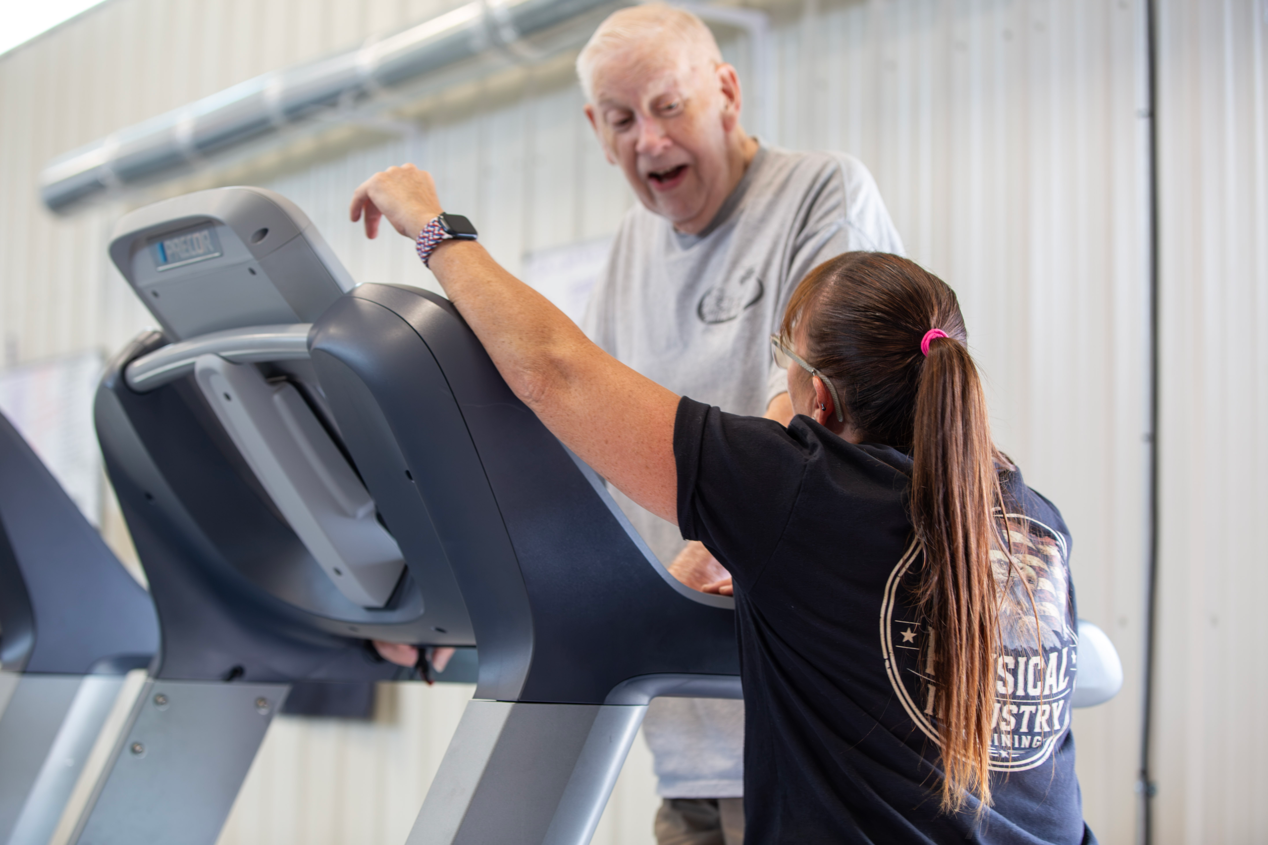 Coach Lori Konen coaching an older adult client during cardio training at Physical Industry Training