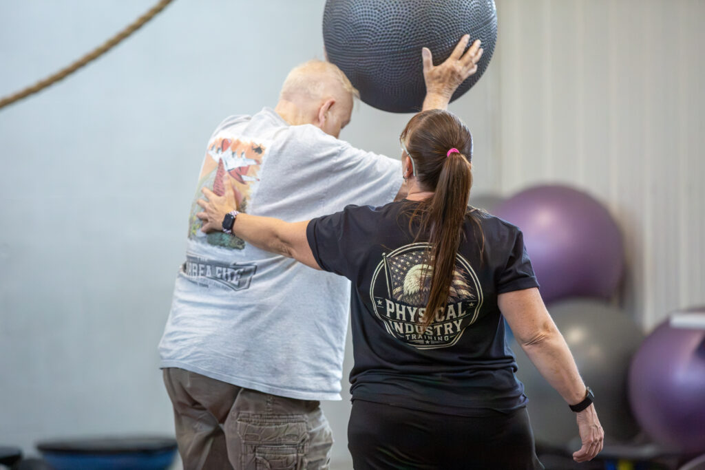 Coach Lori Konen working with an older adult client at Physical Industry Training