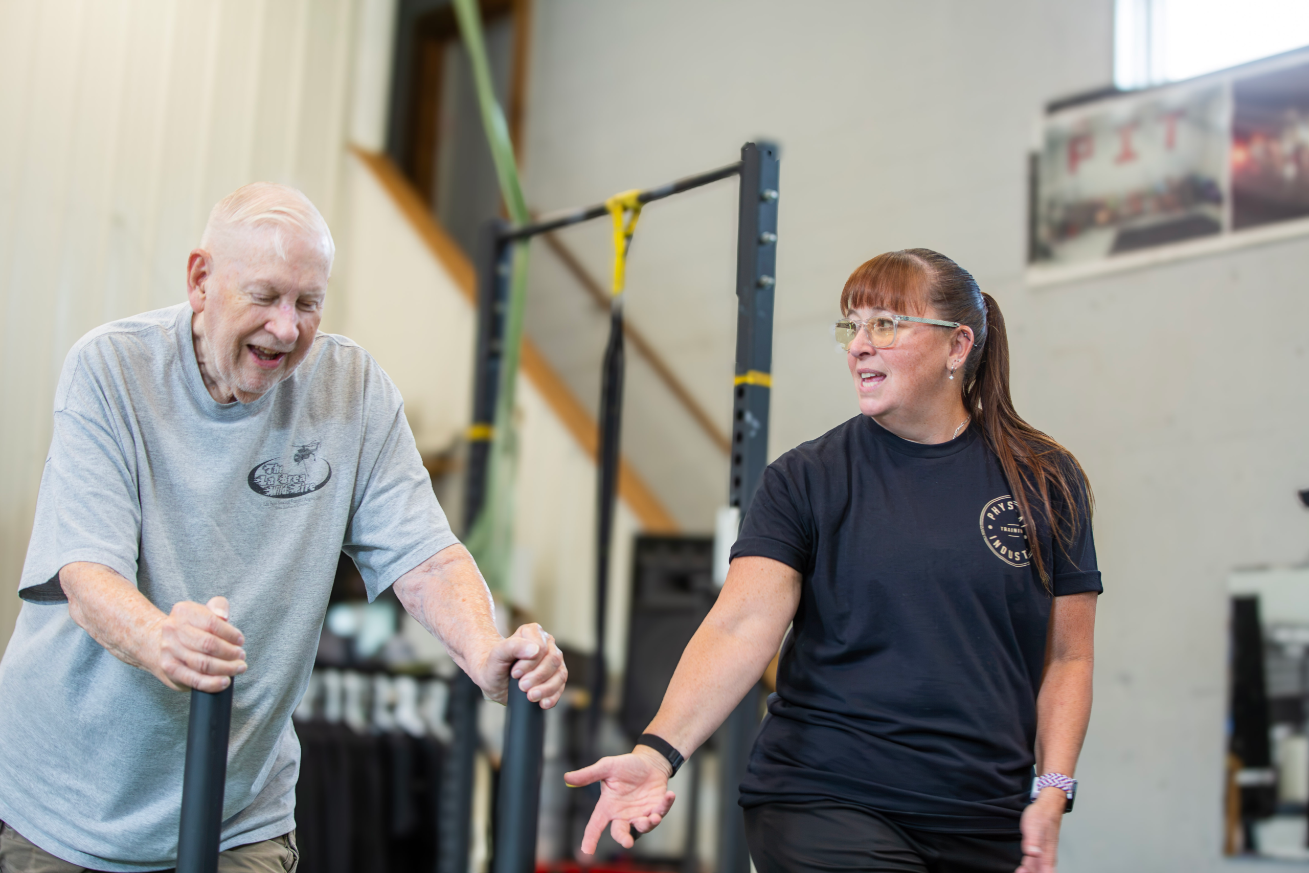 Coach Lori Konen coaching an older adult client during movement training at Physical Industry Training
